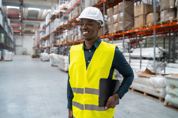 istock A distribution manager is walking through a storage area wearing protective workwear and a hardhat 1731264451