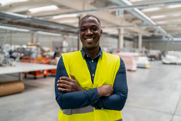 Portrait of a factory worker wearing safety vest stock photo