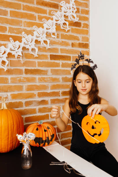 istock Creative girl decorating for the Halloween holiday 1731266202