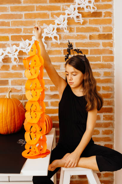 istock Creative girl decorating for the Halloween holiday 1731266767