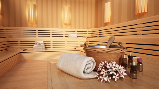 Massage oils, traditional accessories and towels standing on a Finnish sauna seat. Wellbeing concept.