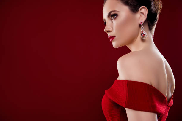 istock Photo of confident cool lady naked shoulders expensive earrings empty space isolated ruby color background 1731284112