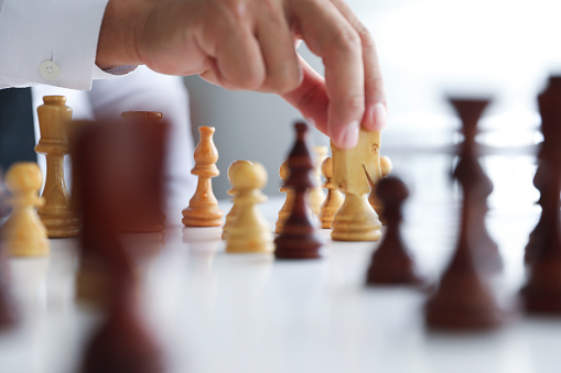 Business strategy concept with businessman and chess pieces