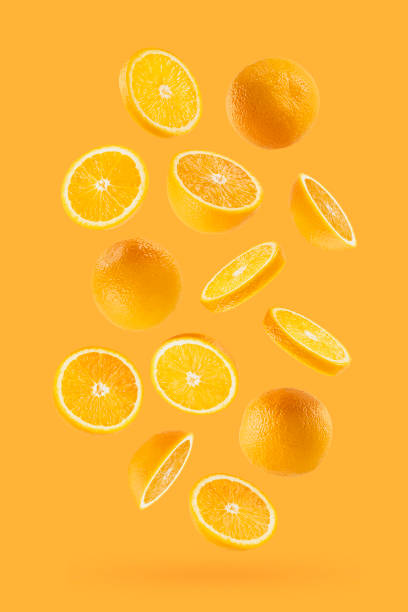 istock Bright oranges as flow fly or fall as art composition. Whole, half, round slices fruits on pastel orange background with shadow. Tropical fruits for advertising, design, label product, poster, card. 1731304688
