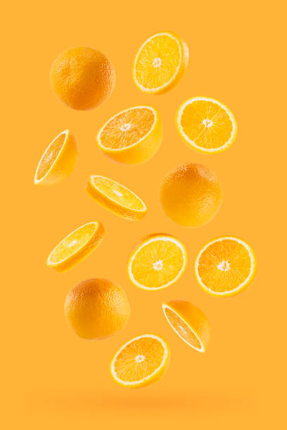 istock Juicy oranges as flow fly or fall as art composition. Whole, half, round slices fruits on pastel orange background with shadow. Tropical fruits for advertising, design, label product, poster, card. 1731305204