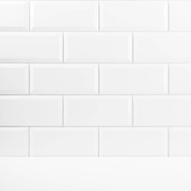 istock Abstract interior with white ceramic rectangle tiles on wall and wood floor or shelf, mockup, empty. Template for presentation, showing, design in soft light minimalistic style. 1731305254