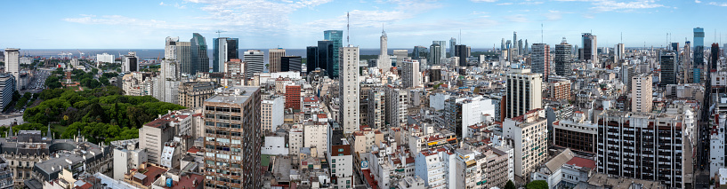 This panoramic shot unveils the sprawling cityscape of downtown Buenos Aires, where the urban architectural expanse meets the serene sea at the horizon. The skyline, adorned with a mix of modern and historic buildings, tells tales of the city’s vibrant cultural and architectural heritage. The calm waters in the background provide a contrasting serenity to the bustling city life, creating a picturesque juxtaposition that captures the essence of Buenos Aires. This image encapsulates a unique blend of urban dynamism and natural tranquility, portraying a comprehensive view of Argentina's enchanting capital.