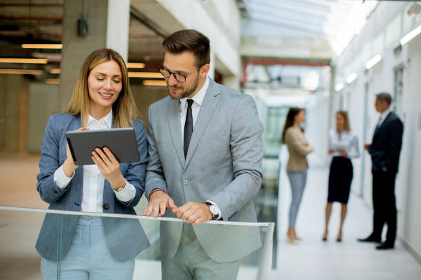 istock Business couple holding digital tablet and discussing company strategy 1731308549