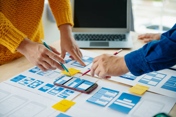 istock View of UI developer team brainstorming on their project with laptop, smartphone and digital tablet. Creative digital development agency. 1731320175