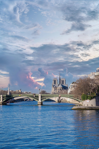 Paris, the Sully bridge on the Seine, and the Notre-Dame cathedral in background