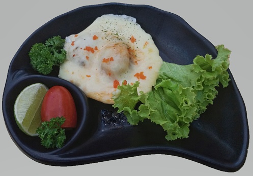 Baked Scallops with Cheese in black plate-Food ingredients concept