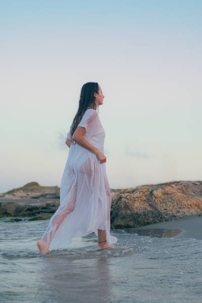 istock Young beautiful woman runs on a seashore at sunset 1731332952