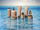 Beauty products blue shallow water against rising sun background