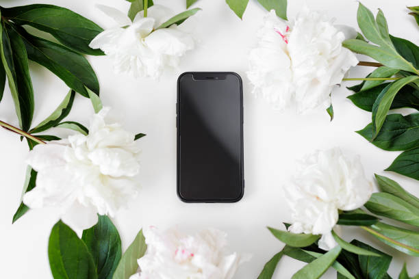 istock Black telephone and white peonies on table 1731339485