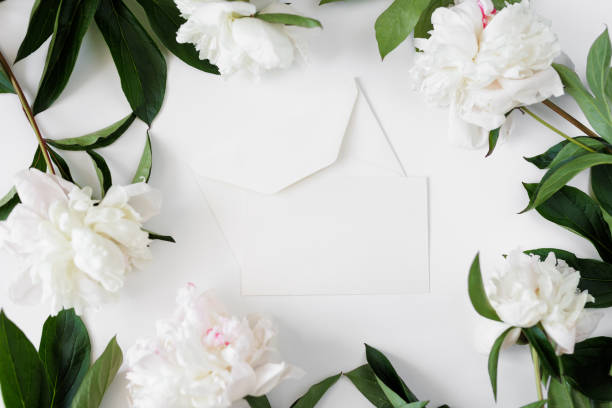 istock Open envelope with a letter and peonies, place for your text 1731339486