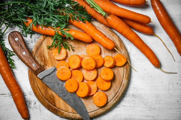 istock Fresh chopped carrots on cutting board. 1731362709