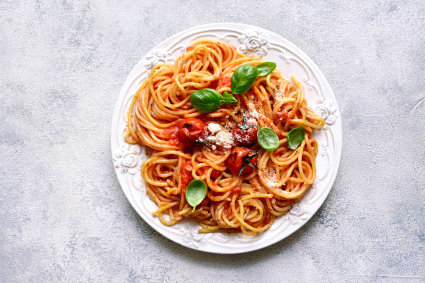 istock Spaghetti with grilled tomatoes. Top view with copy space. 1731368383