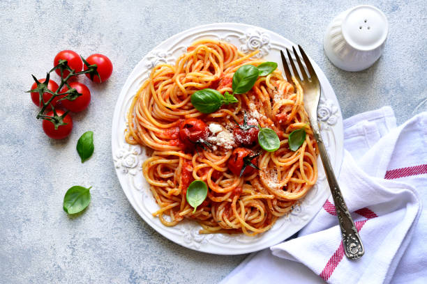 istock Spaghetti with grilled tomatoes. Top view with copy space. 1731368972