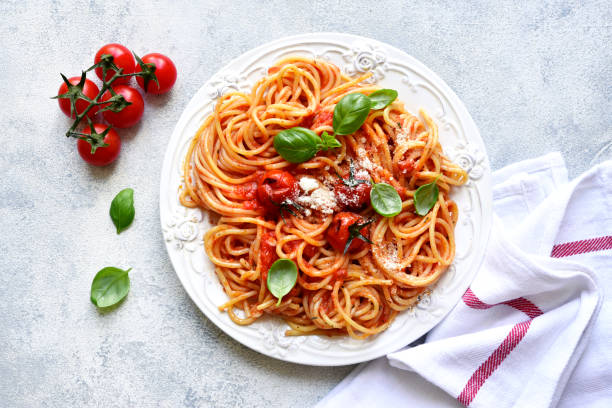 istock Spaghetti with grilled tomatoes. Top view with copy space. 1731370680