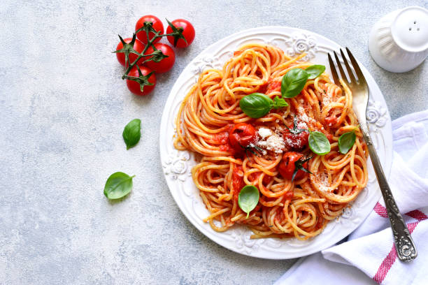 istock Spaghetti with grilled tomatoes. Top view with copy space. 1731370681