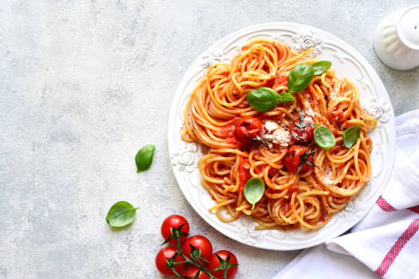 istock Spaghetti with grilled tomatoes. Top view with copy space. 1731370684