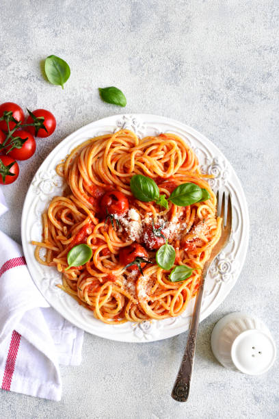 istock Spaghetti with grilled tomatoes. Top view with copy space. 1731371252
