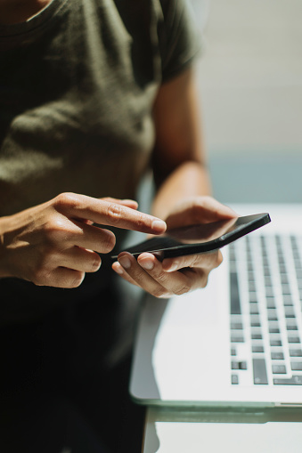 Woman using phone. Close up of hands and smartphone