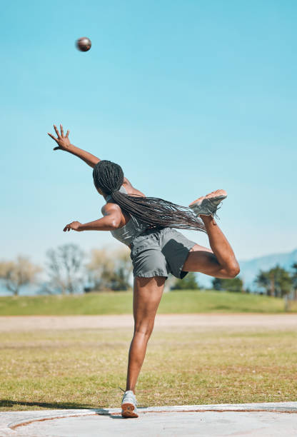 shot put, woman and athlete throw in competition, challenge or training for field event with metal or steel weight. throwing, ball or female in athletics sports, games or outdoor tournament - lançamento do peso imagens e fotografias de stock