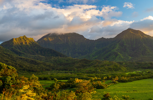 Mountains of the Na Pali mountain range above Hanalei valley in Kauai. Taken just before sunset with the sun lighting clouds