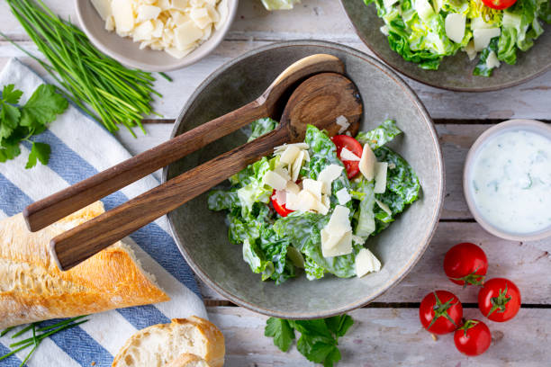 Green salad with tomatoes, bread and parmesan cheese