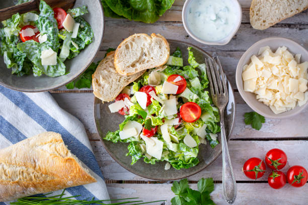 istock Green salad with tomatoes, bread and parmesan cheese 1731419598