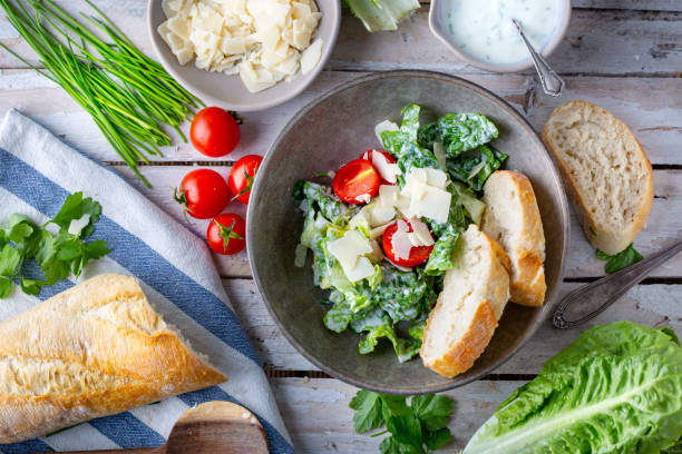 istock Green salad with tomatoes, bread and parmesan cheese 1731420123