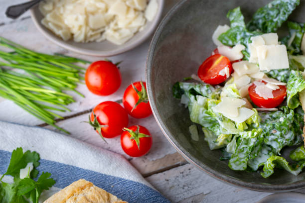 istock Green salad with tomatoes, bread and parmesan cheese 1731420160