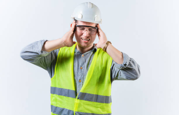 istock Male engineer with headache on isolated background. Young engineer with migraine holding his head isolated 1731420692