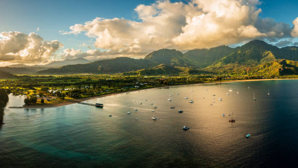 Aerial panorama over the town of Hanalei and valley at sunrise Aerial view of the bay and town of Hanalei with famous pier as the sun rises over the wildlife refuge north shore stock pictures, royalty-free photos & images