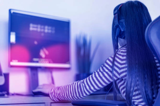 istock teenage girl playing computer games with light effect 1731433513