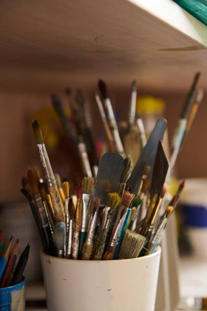 istock Still life with oil paintbrushes near canvas in workshop. Fine art. Visual art. Creative hobby and occupation. Painting 1731441504