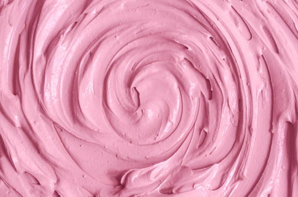 Rose cosmetic clay (alginate modeling facial mask, make-up blusher, lipstick, lip gloss) texture close-up, selective focus. Abstract background with circle brush strokes.