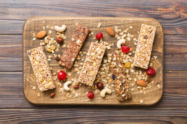 istock Various granola bars on table background. Cereal granola bars. Superfood breakfast bars with oats, nuts and berries, close up. Superfood concept 1731465935