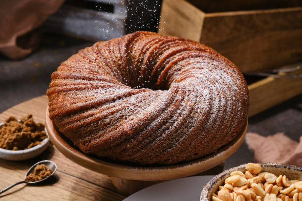 istock Muffin cake  sprinkling icing sugar on the stand. 1731473631