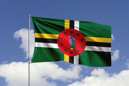 3d illustration flag of Dominica. Dominica flag isolated on the blue sky with clipping path.