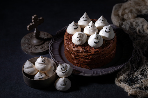 Homemade Chocolate Cake with Chocolate cream and Meringue Ghost for Halloween Party