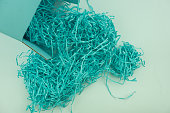 Blue shredded paper for stuffing in a cardboard box