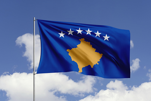 3d illustration flag of Kosovo. Kosovo flag isolated on the blue sky with clipping path.