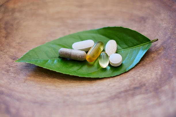 Natural supplements Natural supplements and vitamins. Shallow DOF. pharma herbal medicine pill medicine stock pictures, royalty-free photos & images