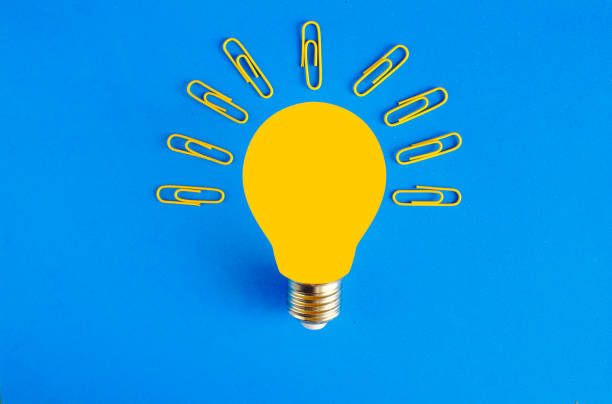 business concept,Brainstorming,innovation,idea,problem solving with a light bulb and paper clips,. Flat lay,free copy space