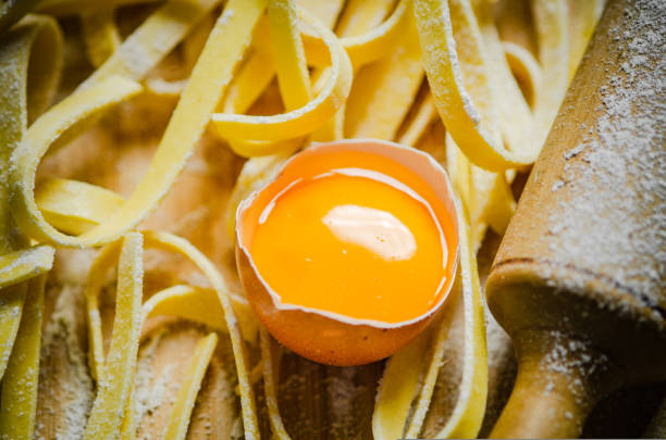 Homemade pasta tagliatelle. On a wooden table.