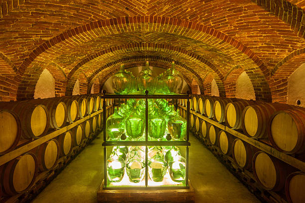 istock Old wine cellar with barrels and bottles 173150978