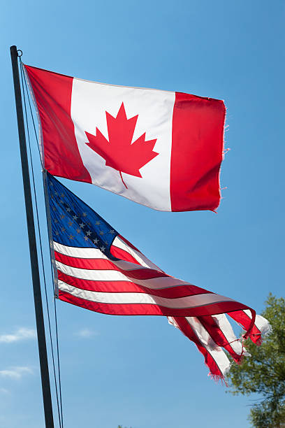 istock Old Canadian and American flags 173153116