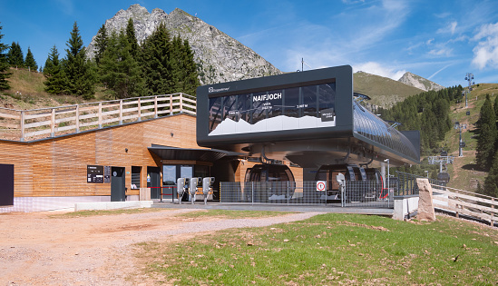 Merano, Italy - 8 August 2023: Merano 2000 Naifjoc station cable car mountain resort with moving cabins for the transport of passengers